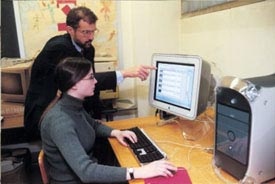 Joe Erickson helping a student on a computer