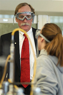 Peter Agre, '70 alumni, in a scince lab speaking with a student.