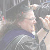 Barbara Lehmann, Social Work, cheers her students during the traditional walk from the Foss Center to Si Melby Hall.