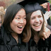 Thwo girls laugh as they pose for a photo after the 2004 Commencement Ceremony.