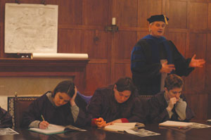 Prof. Quanbeck teaching students in the Medieval Connections class, clad in his doctoral robes.