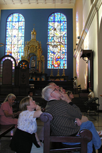 people sitting in an ornate and elaborate church.