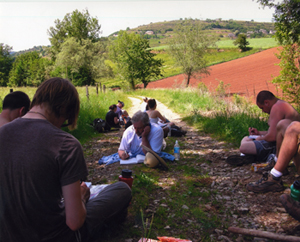Students resting alongside a country road in France