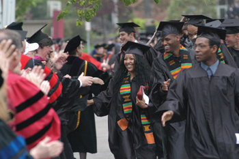 Picture of Augsburg graduates being cheered by faculty.
