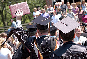 Picture of a man holding a diploma.
