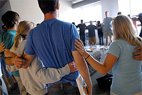 Picture of people standing in a circle.