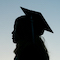 silhouette of student wearing graduation cap and gown
