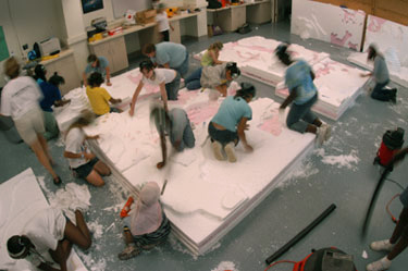 Students in the GEMS/GISE program working with huge sheets of styrafoam, trying to create the surface of Mars.