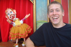 Kyle Loven performing with a clown puppet.