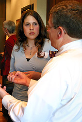 Picture of President Pribbenow discussing with a Scholastic Connections attendee.